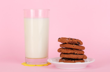 Glass of fresh new milk on pink background