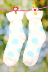 Pair of socks with polka dots hanging to dry