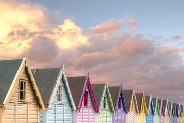 row of beach huts red sky