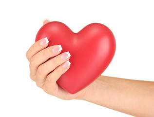 Fototapeta premium Red heart in woman's hand, on white background close-up