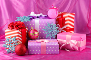 Colorful purple, red and pink gifts with Christmas balls and