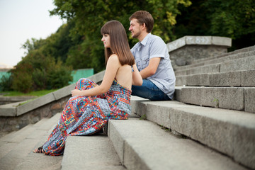 Couple sitting on stairs on green background