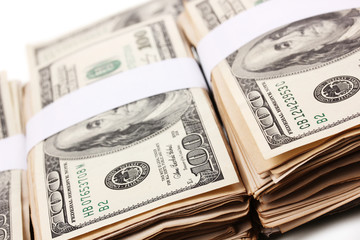 Many one hundred dollars banknotes close-up isolated on white