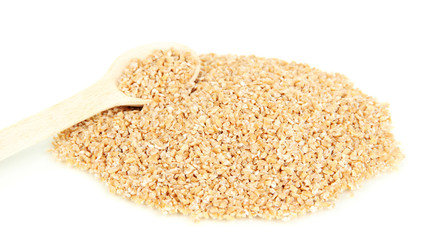 Wheat bran with wooden spoon isolated on white