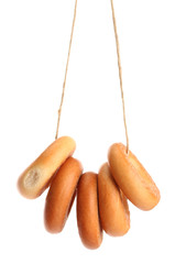 tasty bagels on rope, isolated on white