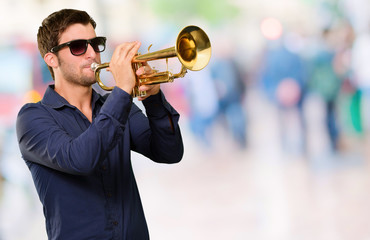 Obraz premium A Young Man Blowing A Trumpet