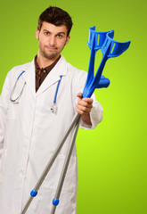 Portrait Of A Doctor Holding Crouches