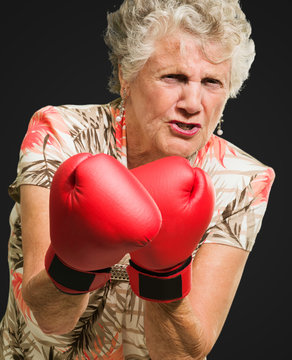 Angry Mature Woman Wearing Boxing Glove
