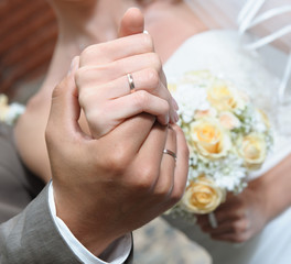 Hands of the bride and groom close-up