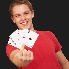 portrait of a young male holding four aces