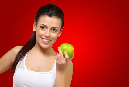 Young woman holding an apple