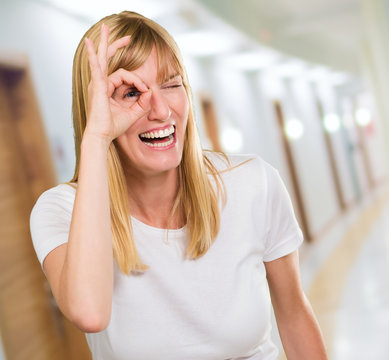 Happy Woman Looking Through Finger