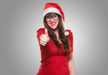 christmas woman doing a thumbs up gesture