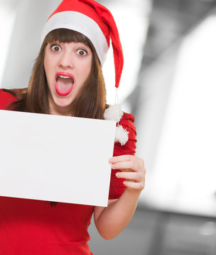 surprised christmas woman holding a blank card