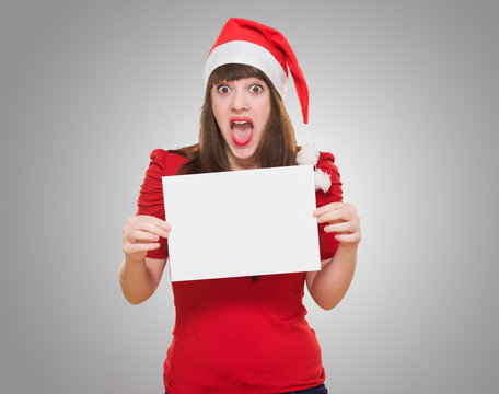 surprised christmas woman holding a blank card