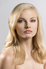 Naklejka premium beauty portrait of pretty blonde girl with serious expression