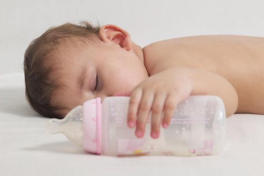 Baby sleeping after drinking here bottle