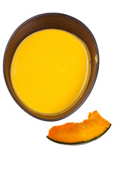 top view on pumpkin soup in black tureen and piece of pumpkin