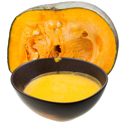 pumpkin soup in ceramic tureen and half of of pumpkin