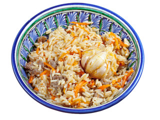 traditional asian pilaf with garlic bulb in ceramic bowl