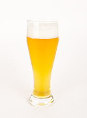 A glass with unfiltered beer on white