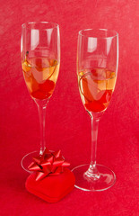 Two champagne goblets with jeweller box on red