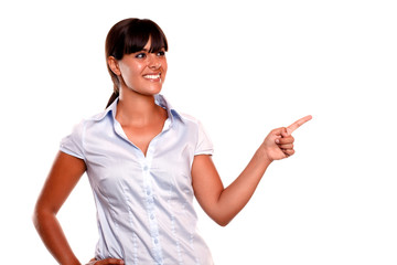 Charming young woman pointing her left