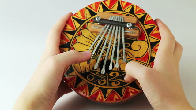 person plays a musical instrument kalimba