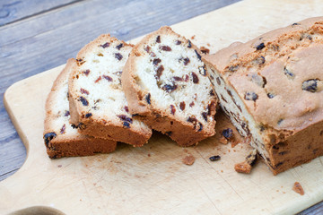 Fresh baked sliced raisin bread on wooden table