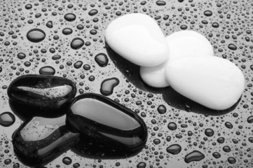 stones of black and white pebbles with water drops