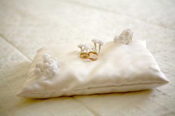 Two wedding rings with white flower in the background, wedding p