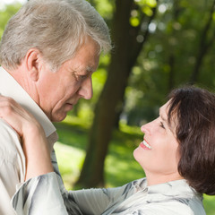 Senior happy couple embracing, outdoors