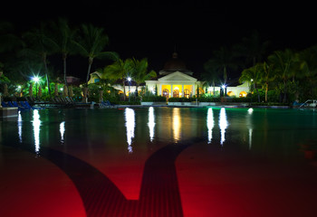 Obraz na płótnie Canvas Pavilion with night illumination behind pool