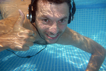 man underwater listen music with head-phones