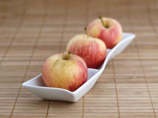 Three apples in a bowl