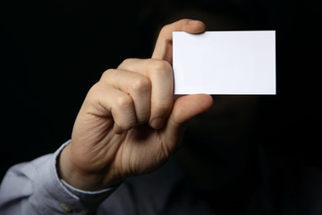 Man holding business card. Close up shot