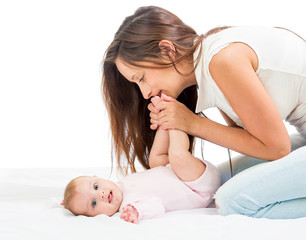 Obraz na płótnie Canvas joyful mother playing with her baby infant