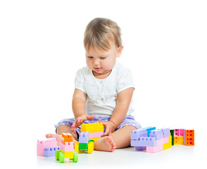 little cheerful child with construction set over white backgroun