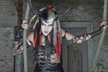 Naklejka premium Scary female demon hanging in ropes.