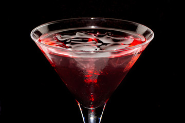 sweet red cocktail on black background