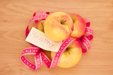 piled apples and measuring tape: eating healthy