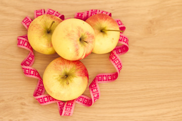 heart made of apples and measuring tape