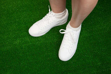 tennis sneakers on green