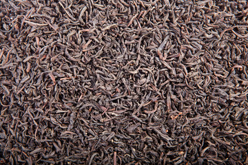 Black tea loose dried tea leaves, isolated on the white backgrou