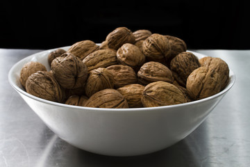 bowl with walnuts on steel table