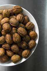 bowl with walnuts on steel table