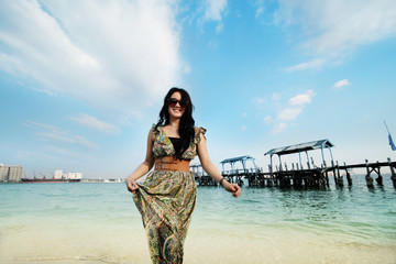 black long hair young 20s beautiful asian woman in beach vacation and relaxing posing with wooden pier at background