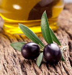 Ripe black olives with leaves.