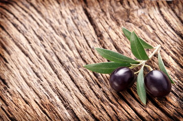 Ripe black olives with leaves.