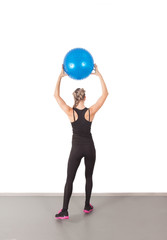 Athletic young woman with blue ball